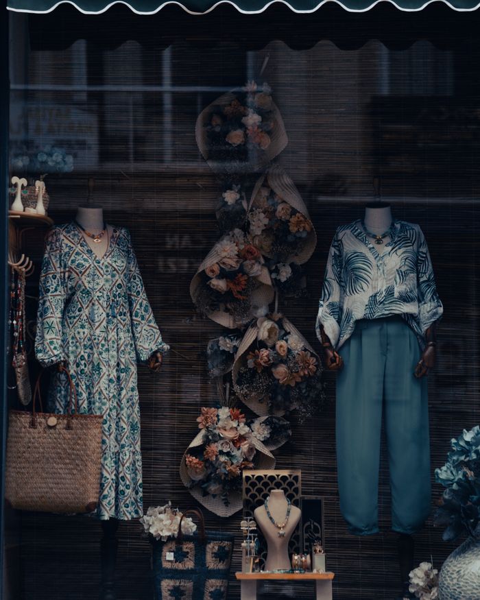 The Art of Drawing Readers In: Your attractive post title goes here Elegant storefront display featuring mannequins adorned with stylish outfits and floral arrangements.