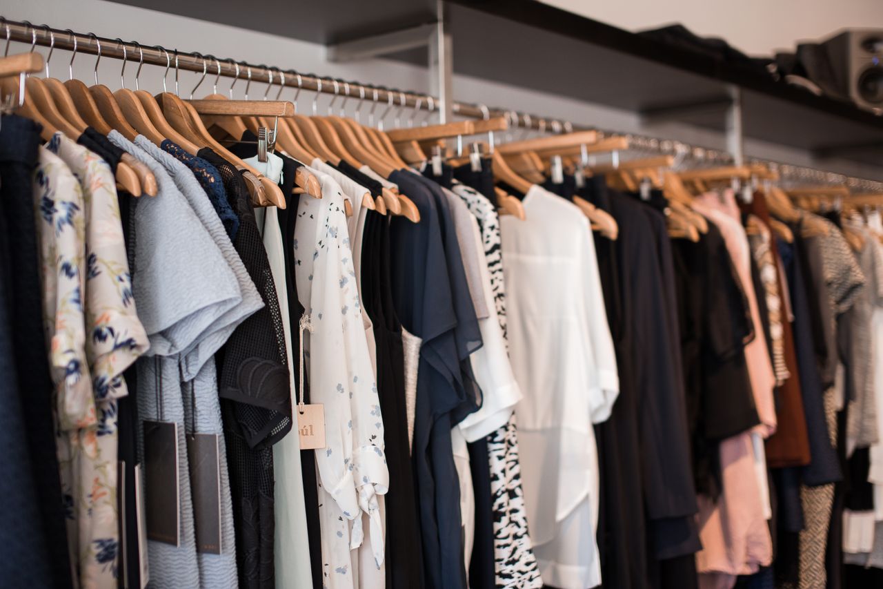 Crafting Captivating Headlines: Your awesome post title goes here Vibrant clothing display on wooden hangers in a modern boutique setting.